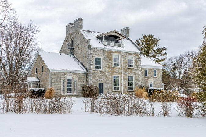 Exterior real estate photography example by Show Kingston – winter view of stone home near Kingston, Ontario